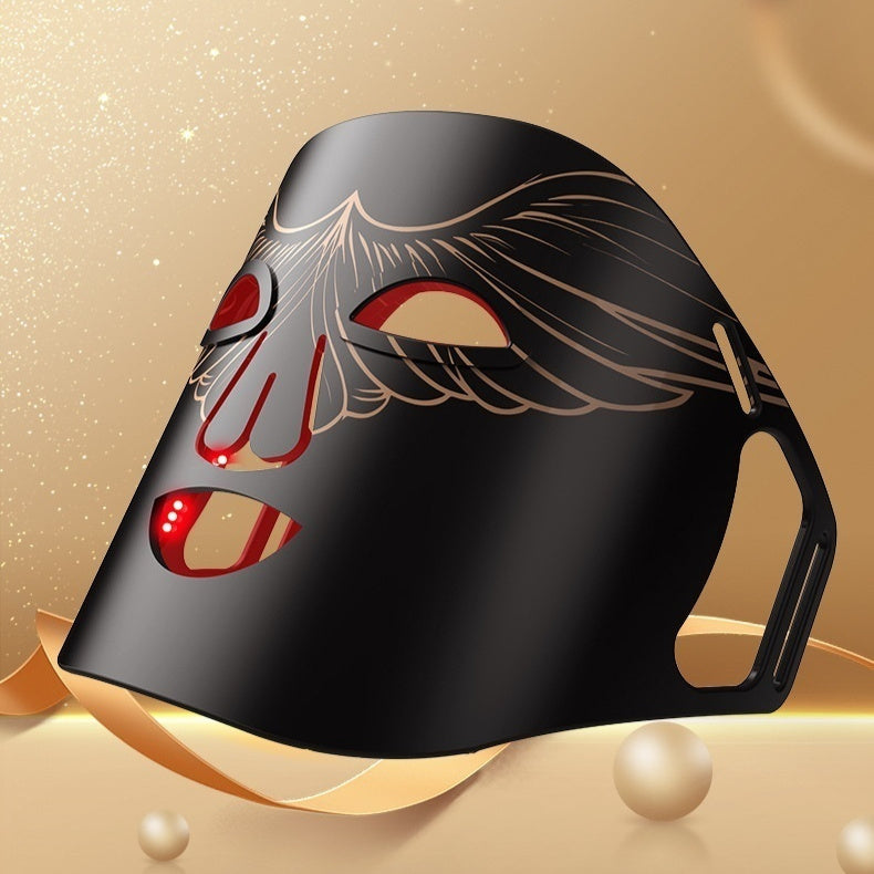 Black mask with red accents on a gold background