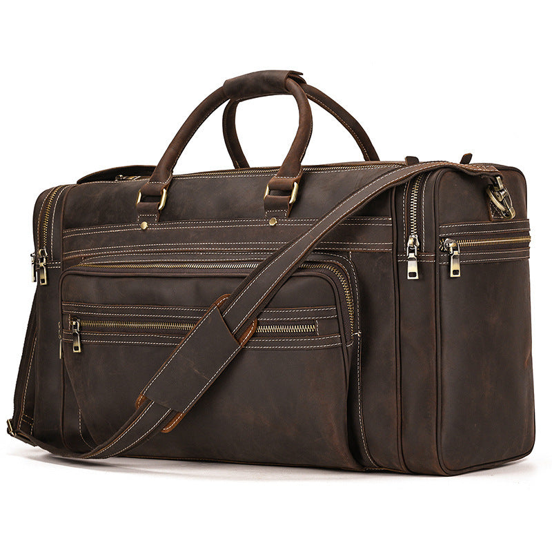Brown leather briefcase with multiple zippers on a white background