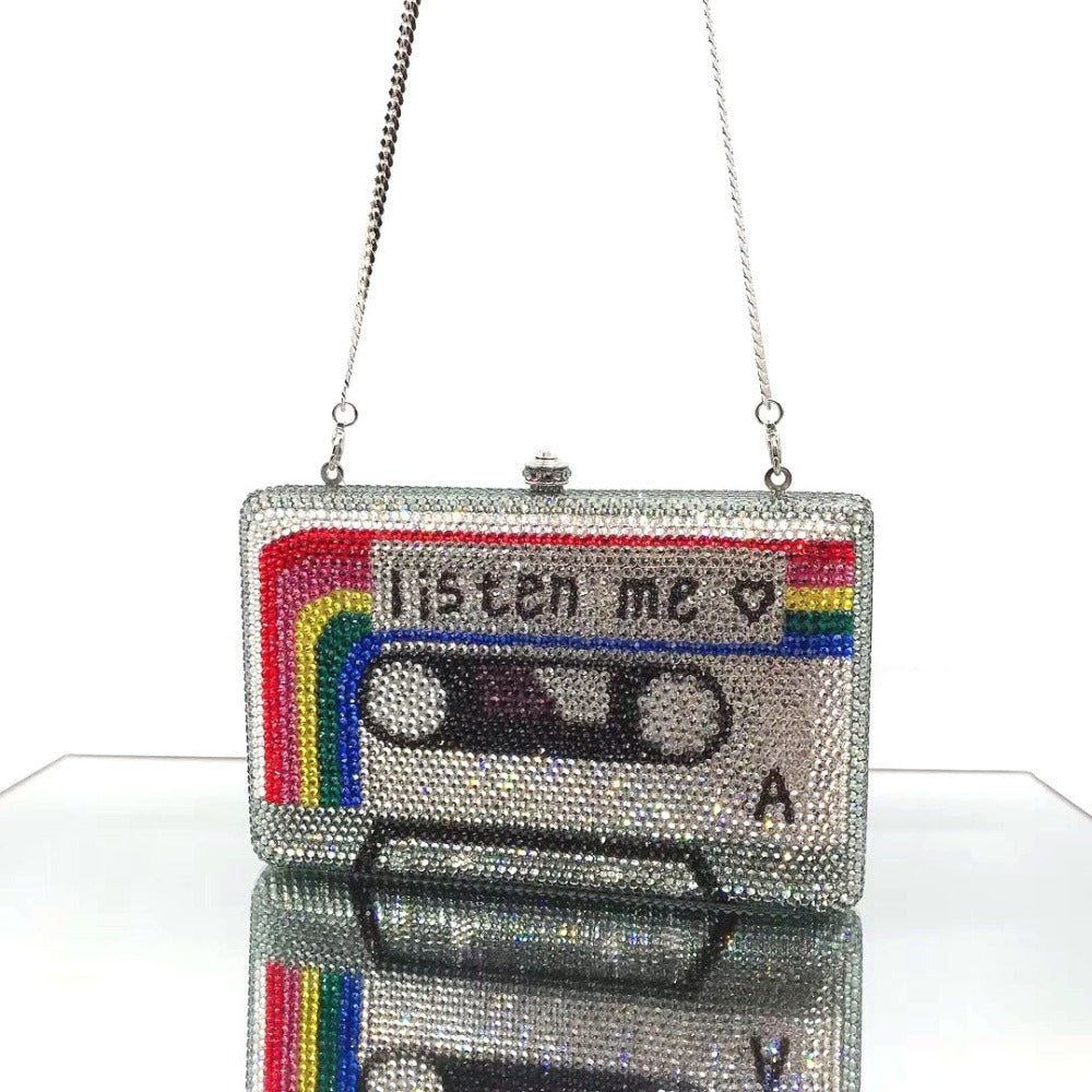 Sparkly cassette tape purse with 'listen me' text on a white background