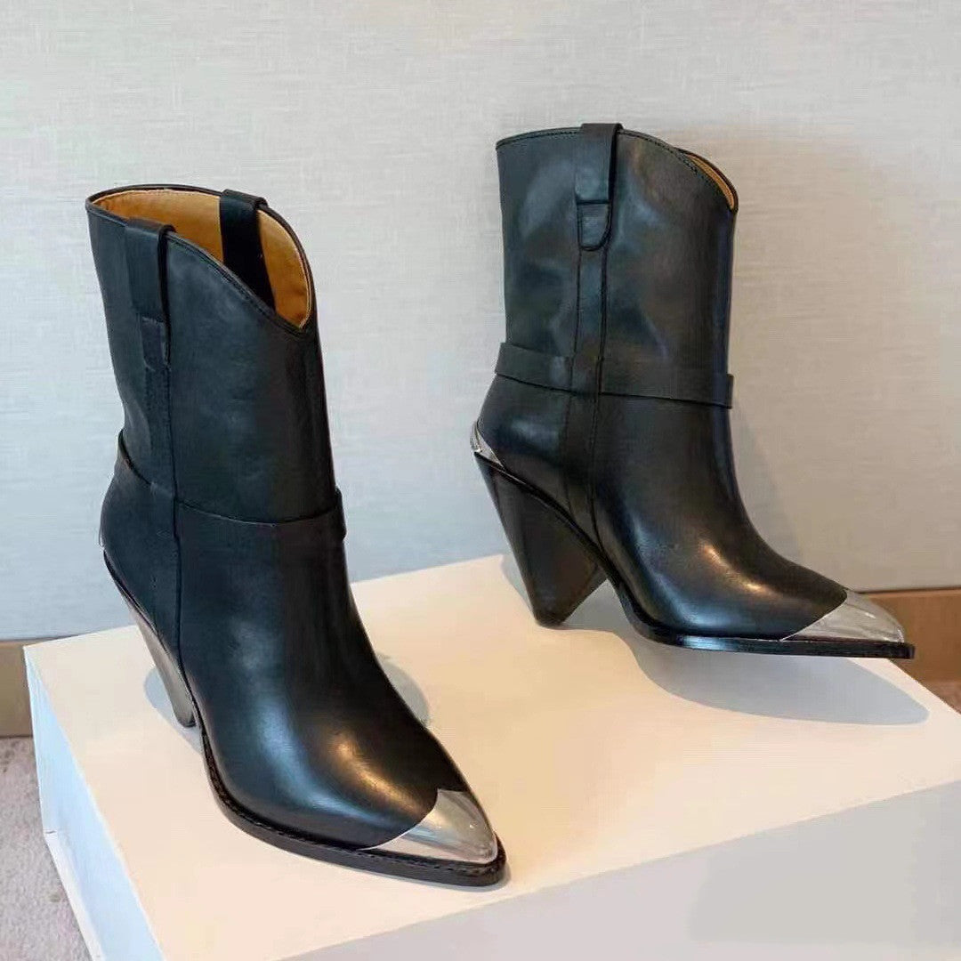 Pair of black leather boots with metallic soles on a light gray surface.