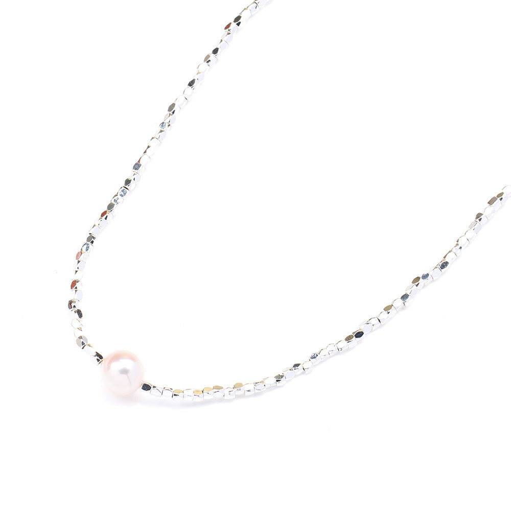 Necklace with a single pearl on a white background