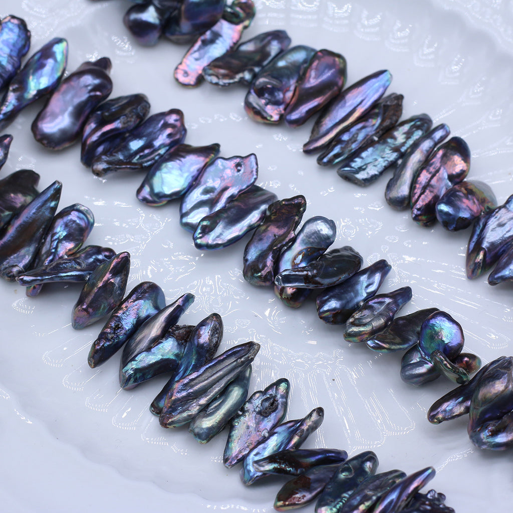 Iridescent shell beads on a white surface
