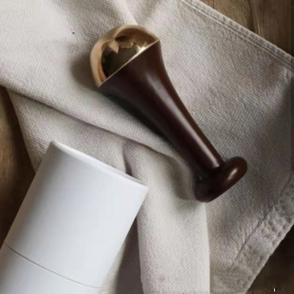 Brown wooden tool on a textured beige fabric surface