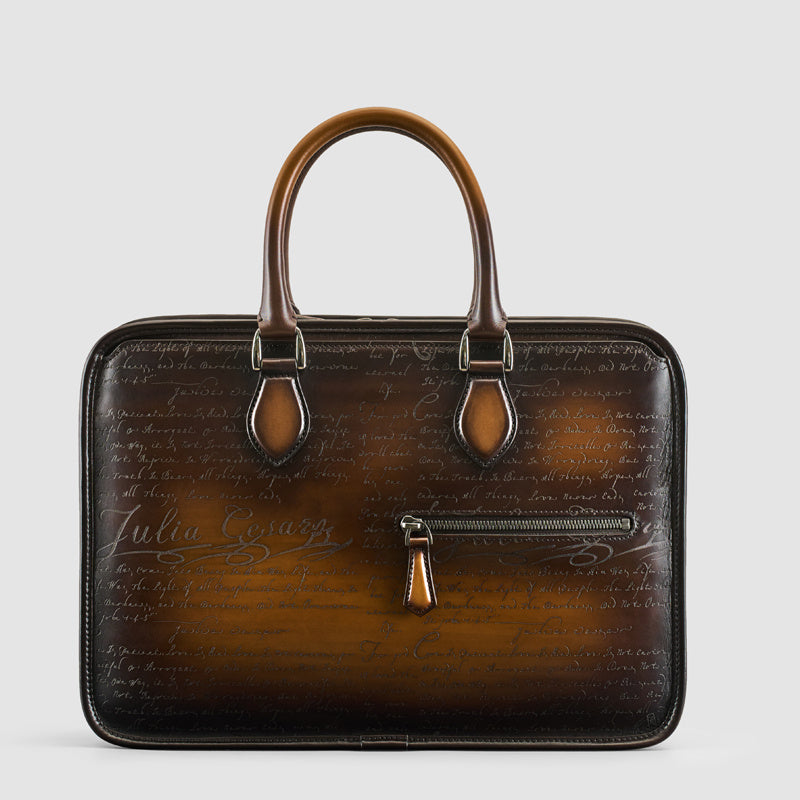 Brown leather briefcase with script design on a light gray background