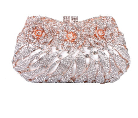 Elegant clutch bag with rose gold and silver embellishments on a white background
