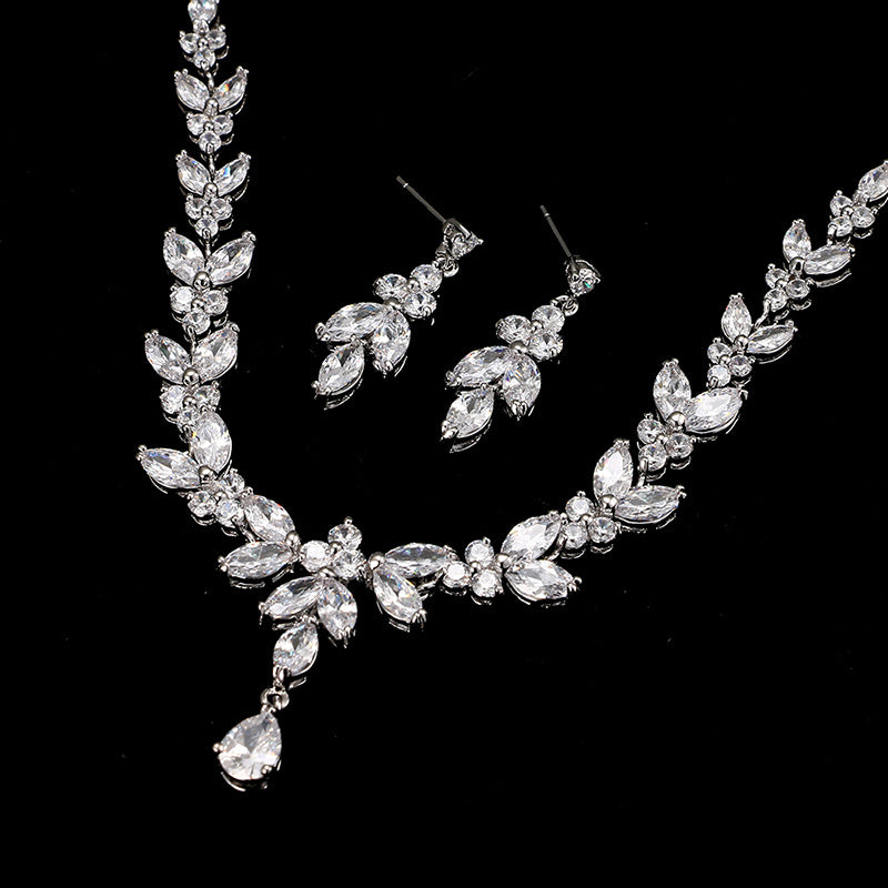 Silver jewelry set with necklace and earrings on a black background