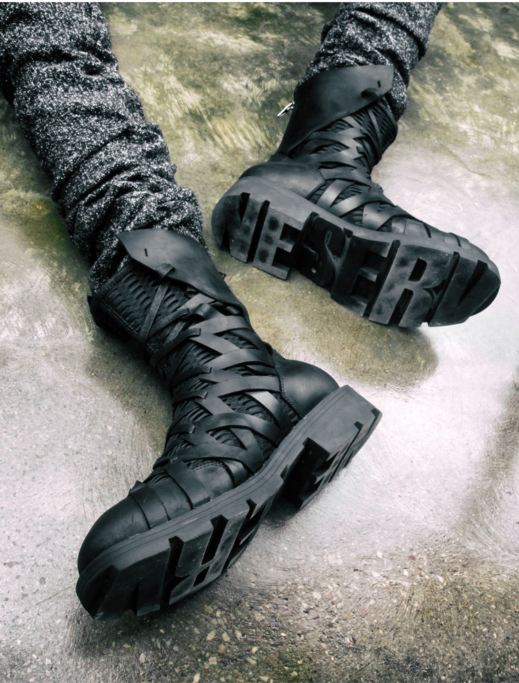 Black high-top boots on a concrete floor