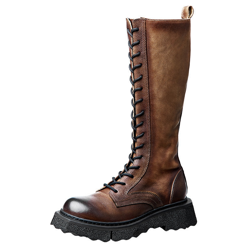 Brown leather boot with black laces on a white background