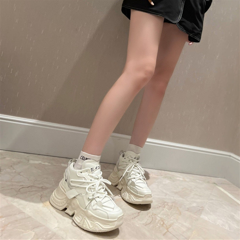 White sneakers worn with a neutral background