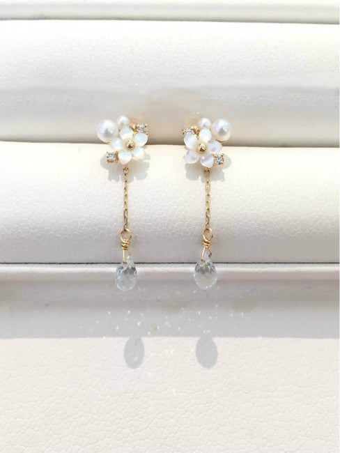 Pearl earrings with clear beads on a white background