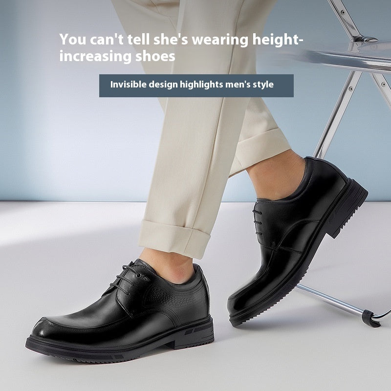 Black dress shoes worn with beige pants on a light background