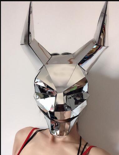 Metallic mask with a geometric design on a plain background
