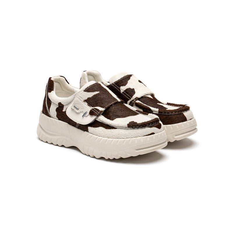 Pair of white and brown children's sneakers on a white background