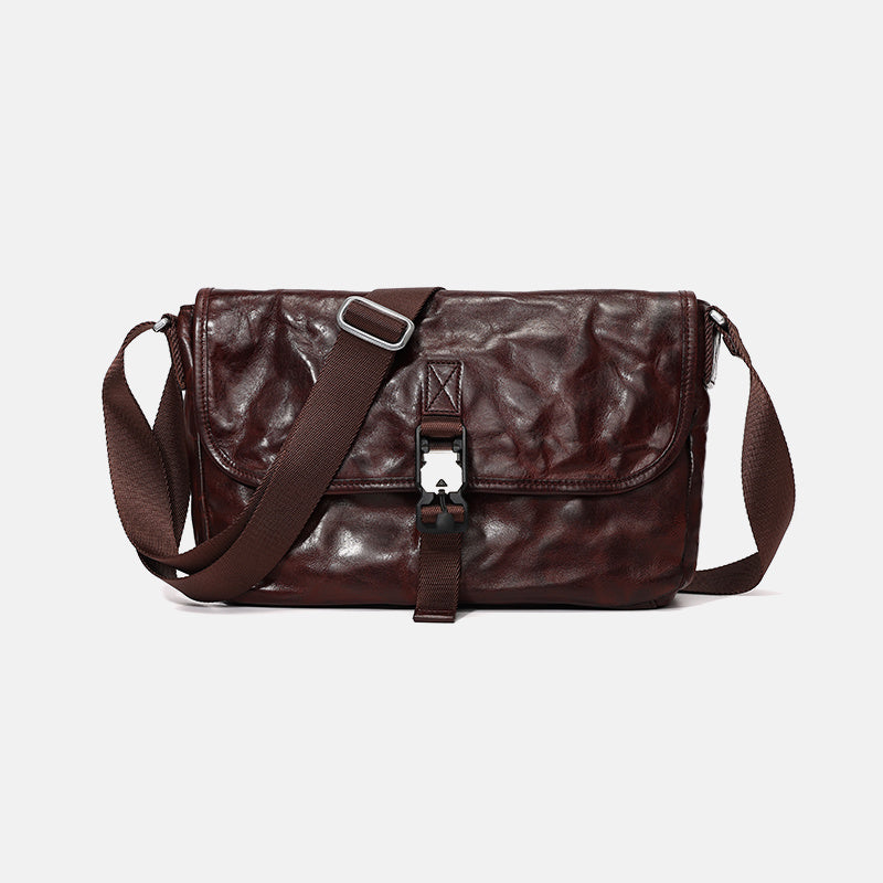 Brown leather bag with a strap on a light gray background