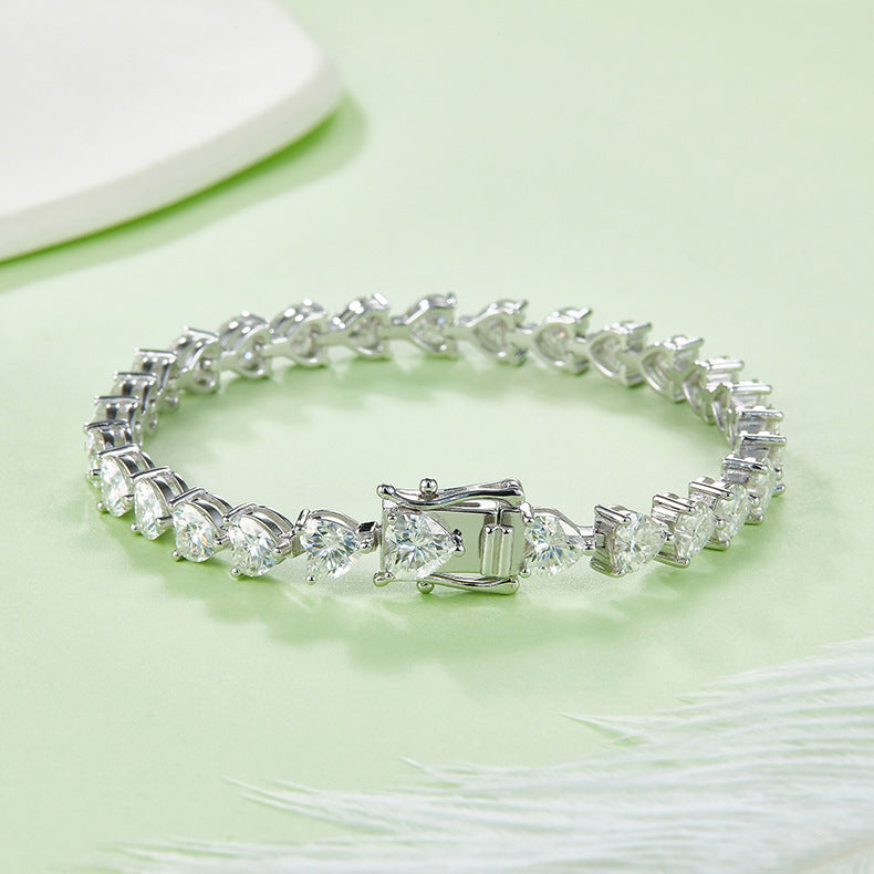 Silver bracelet with clear gemstones on a light green background