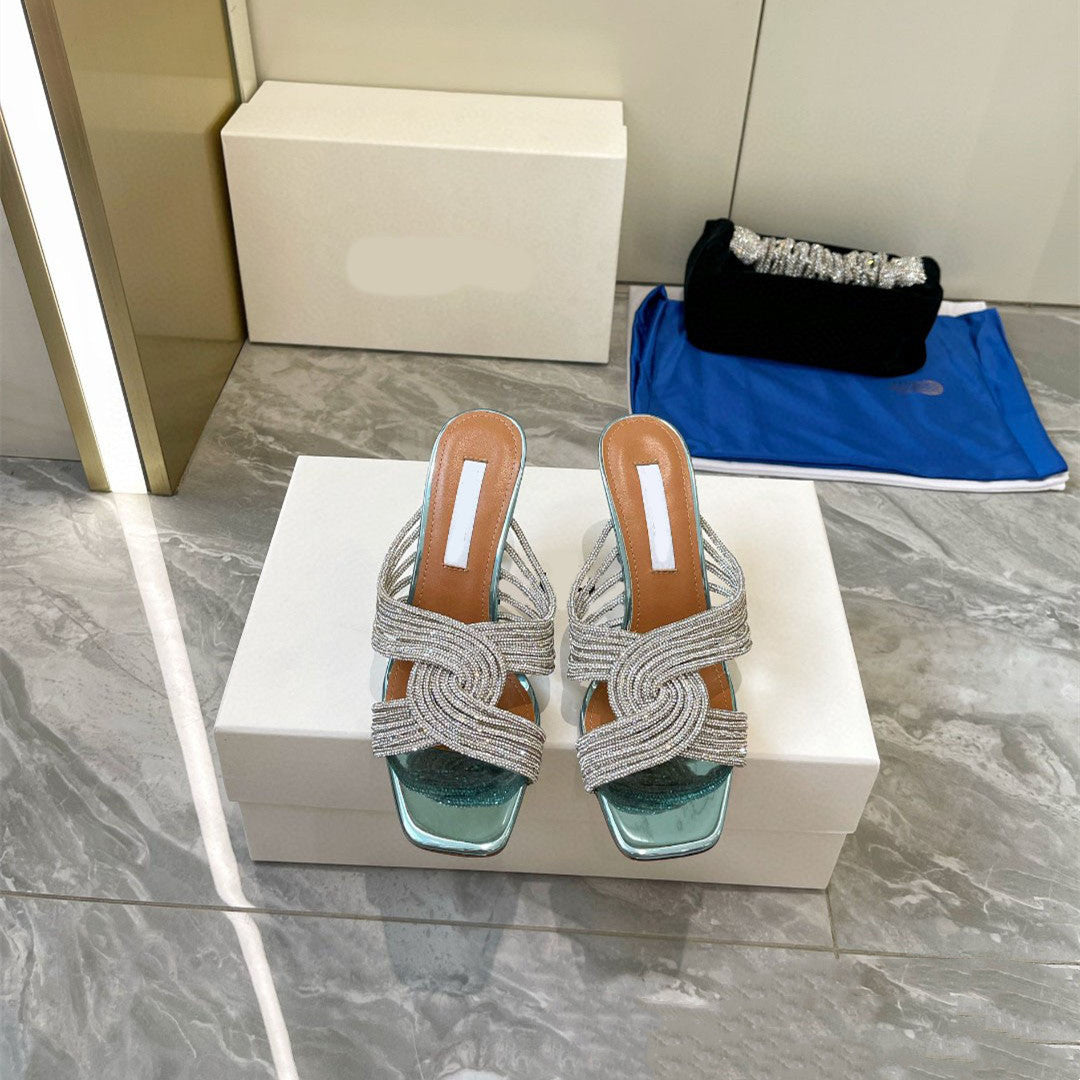 Pair of strappy sandals on a white box with a blurred background
