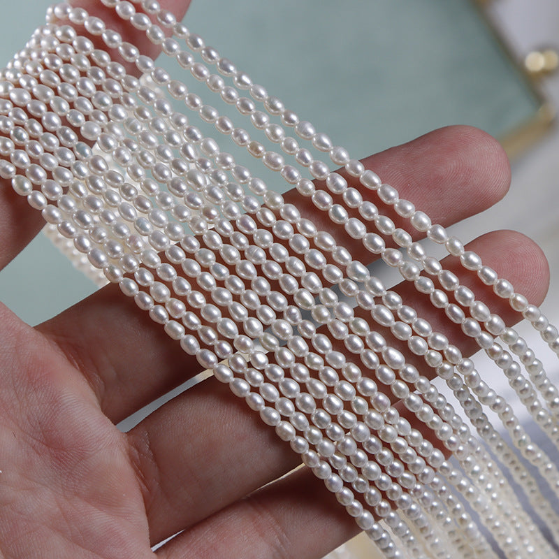 Pearl necklace held in a hand with a blurred background