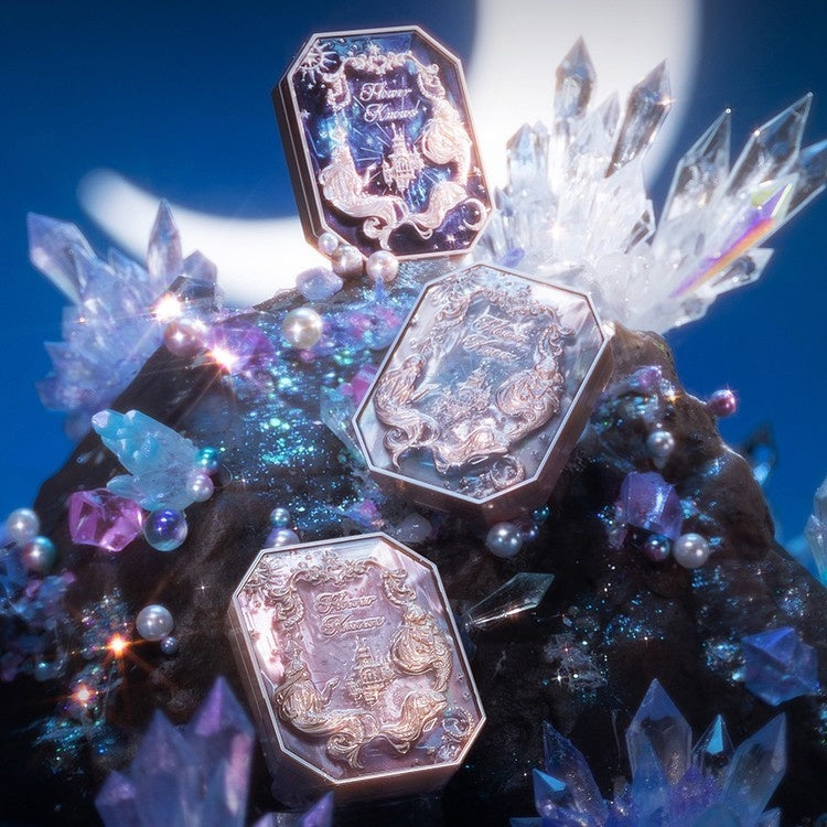 Decorative brooch with gemstones and crystals on a blue background