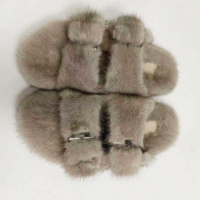 Pair of gray fur slippers on a white background