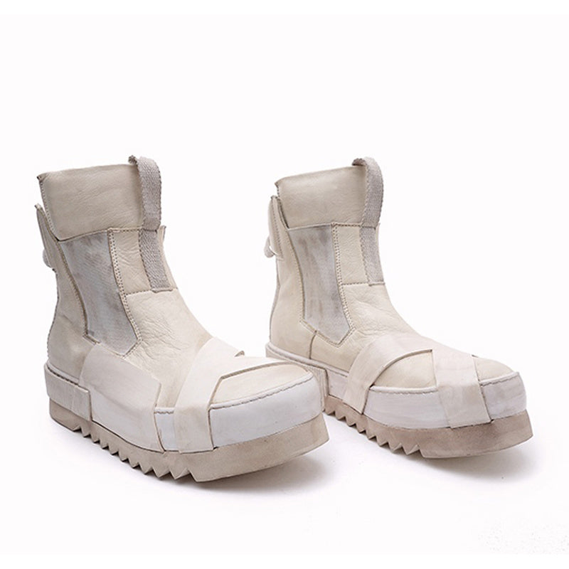 Pair of white platform boots on a white background