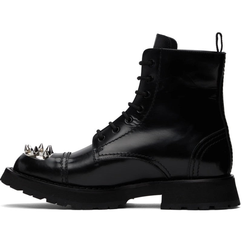 Black leather boot with spiked heel on a white background