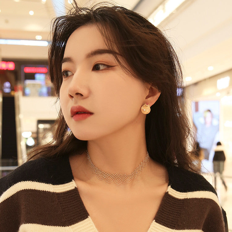 Woman wearing a black and white striped sweater with a blurred indoor background