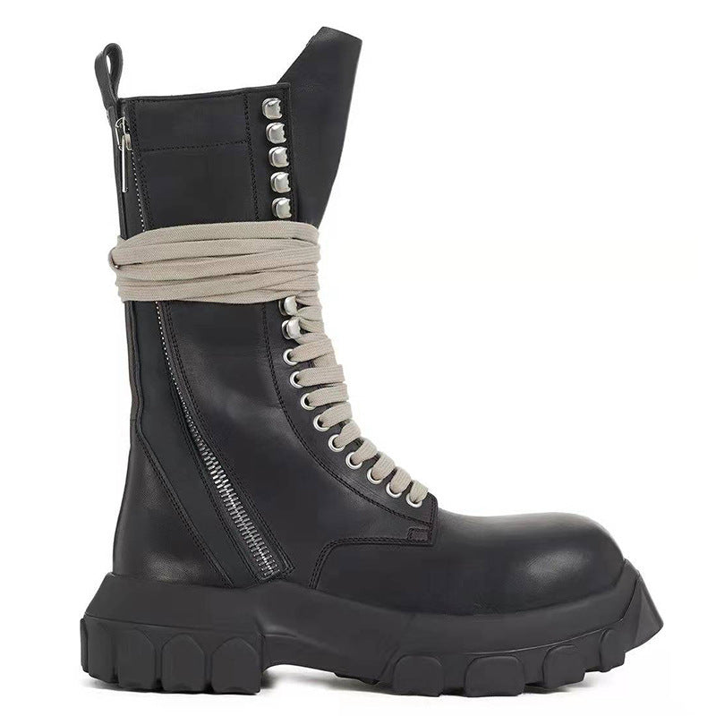 Black leather boot with gray laces and studded details on a white background