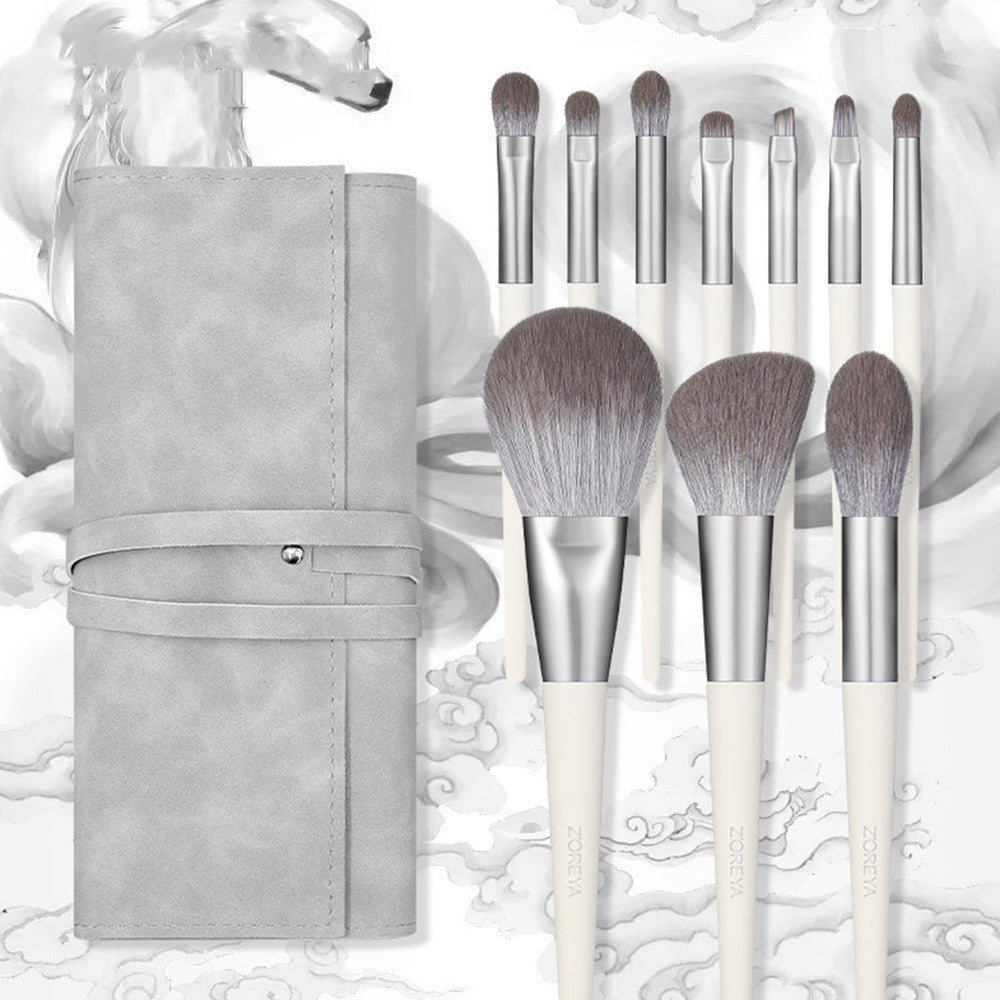 Set of makeup brushes with a gray case on a decorative background