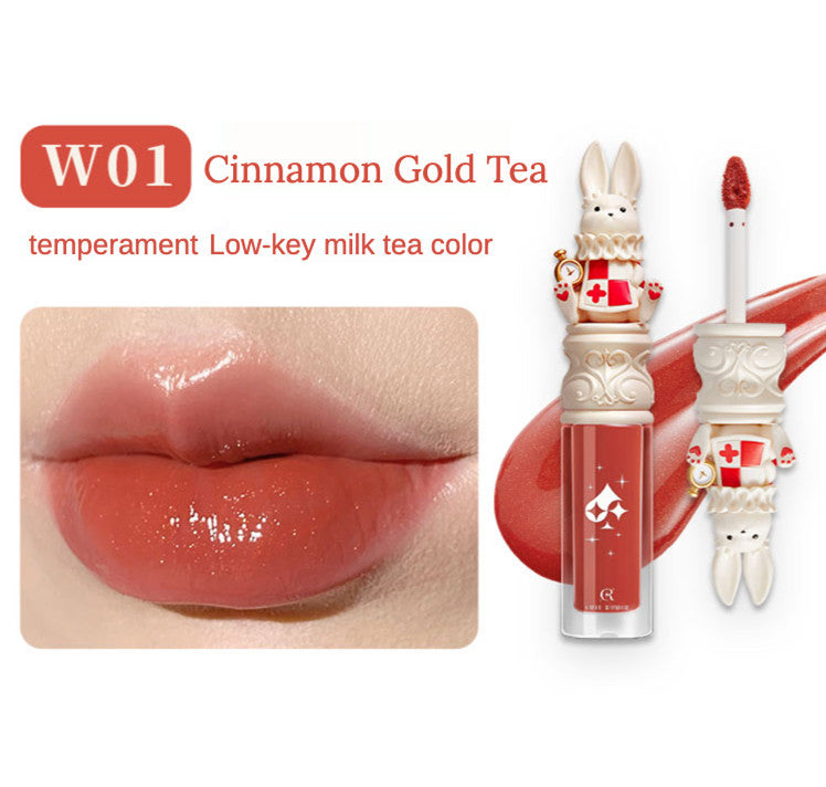 Lip gloss with bunny design and color swatch labeled 'W01 Cinnamon Gold Tea' on a white background.