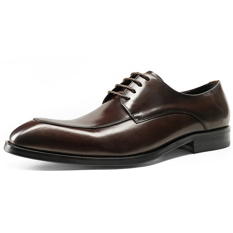 Brown leather dress shoe on a white background