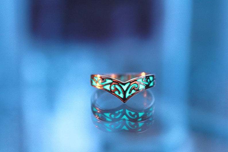 Glowing ring on a reflective surface with a blurred blue background