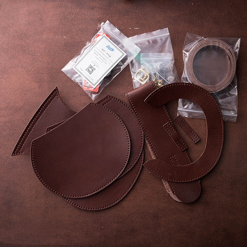 Brown leather components and tools on a brown surface