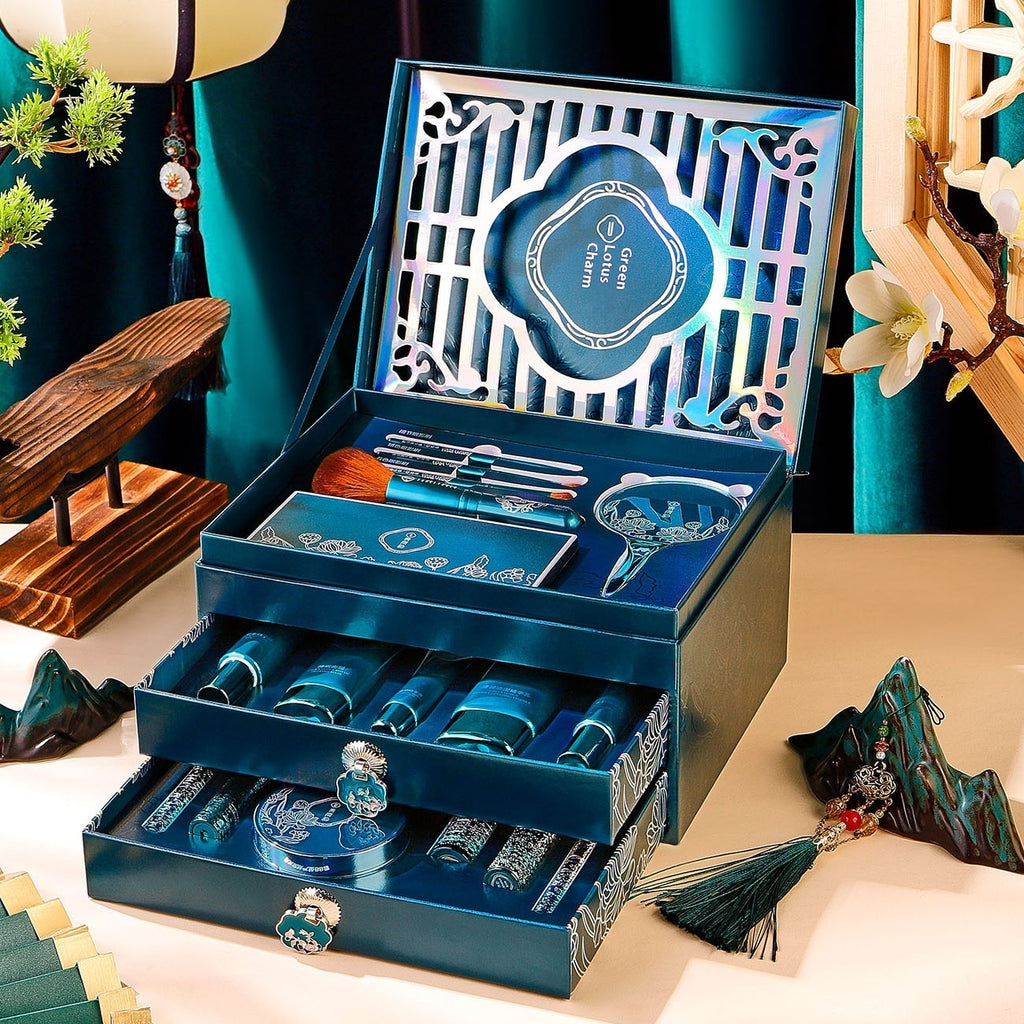 Blue decorative box with intricate designs and a brand logo on a beige surface.