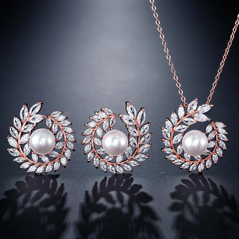 Pearl necklace and earrings set on a dark background
