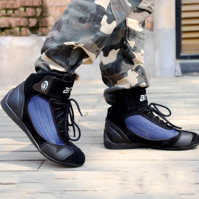Black high-top sneakers with blue lining worn with camouflage pants on a wooden floor.