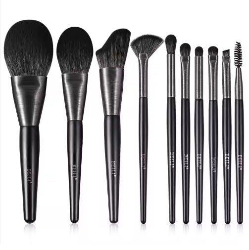 Set of makeup brushes with black and silver handles on a white background