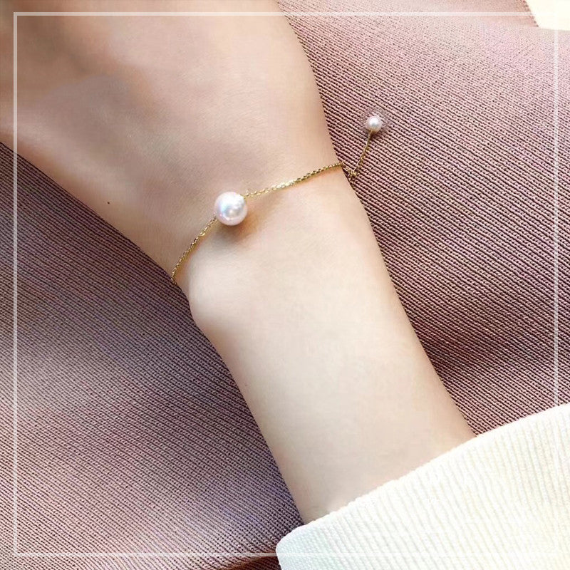 Pearl bracelet on a wrist with a soft background