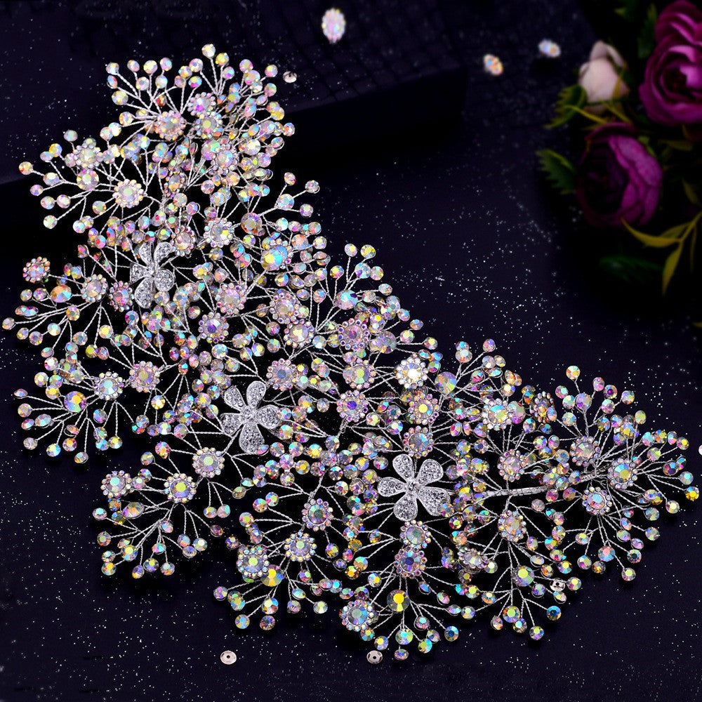 Decorative hairpiece with crystals and flowers on a dark background