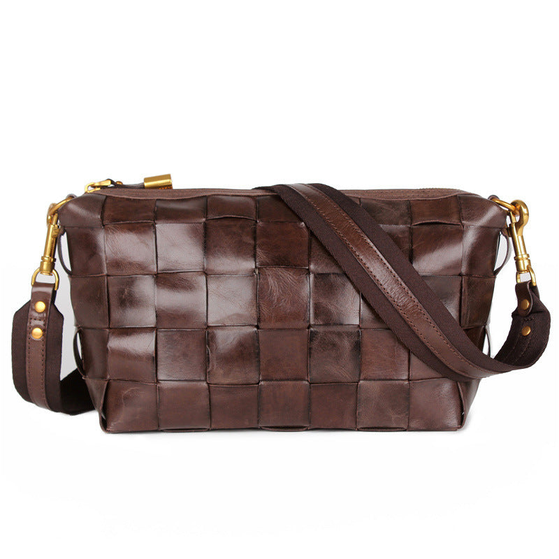 Brown woven leather handbag with gold accents on a white background