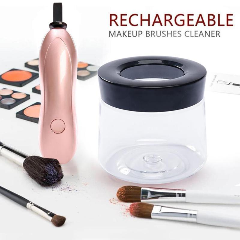 Makeup brushes cleaner with rose gold handle and black top, surrounded by makeup brushes and palettes on a white background.