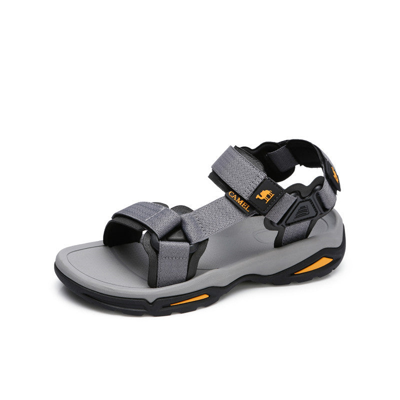 Gray sandal with black and orange accents on a white background