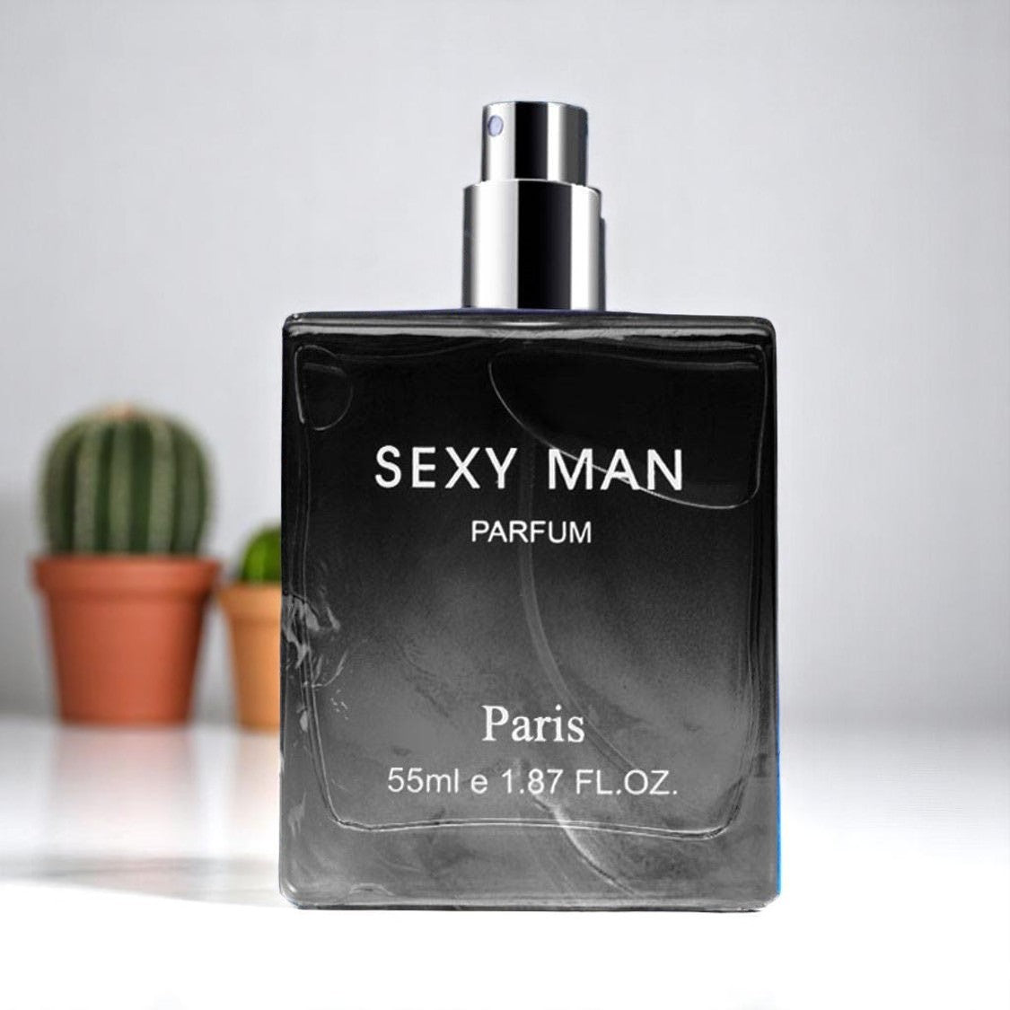Perfume bottle labeled 'Sexy Man Parfum Paris' on a light background with a cactus plant.