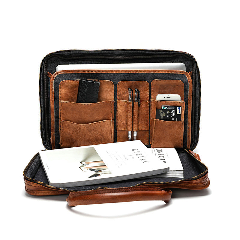 Brown leather briefcase with compartments on a white background