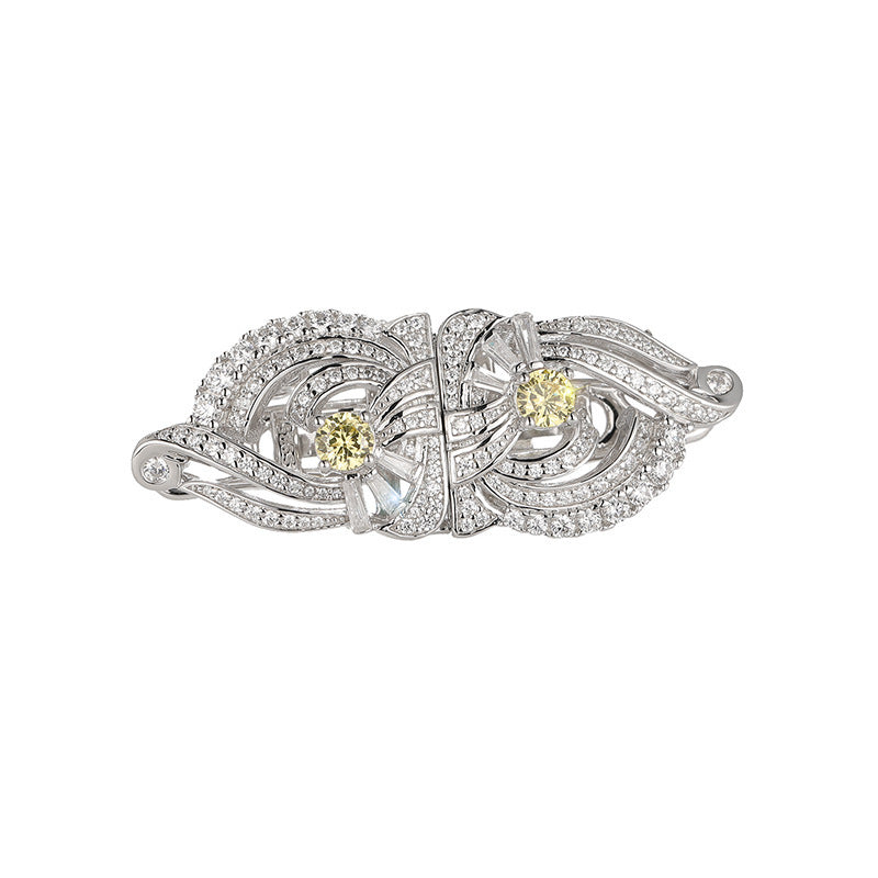 Silver ring with yellow gemstones on a white background