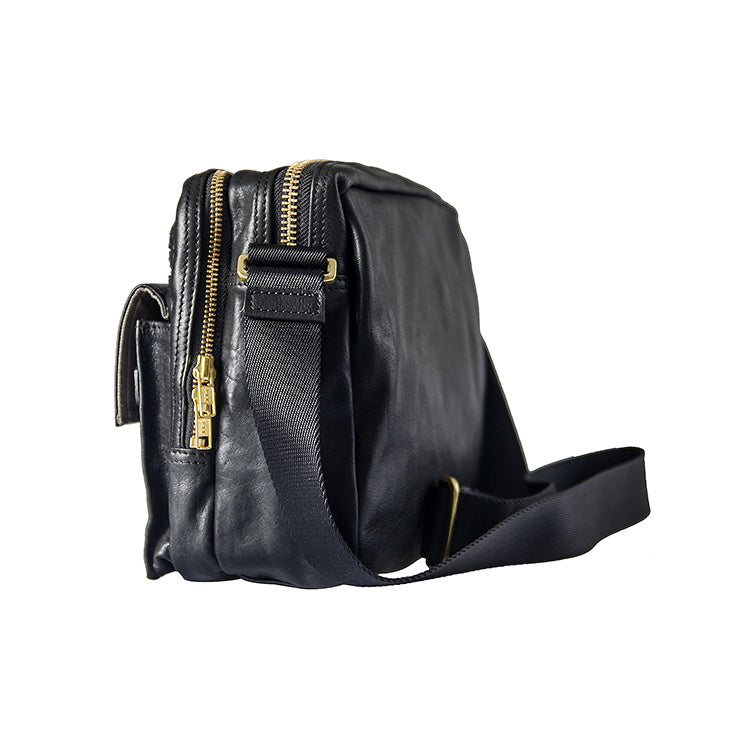 Black leather bag with gold zippers on a white background