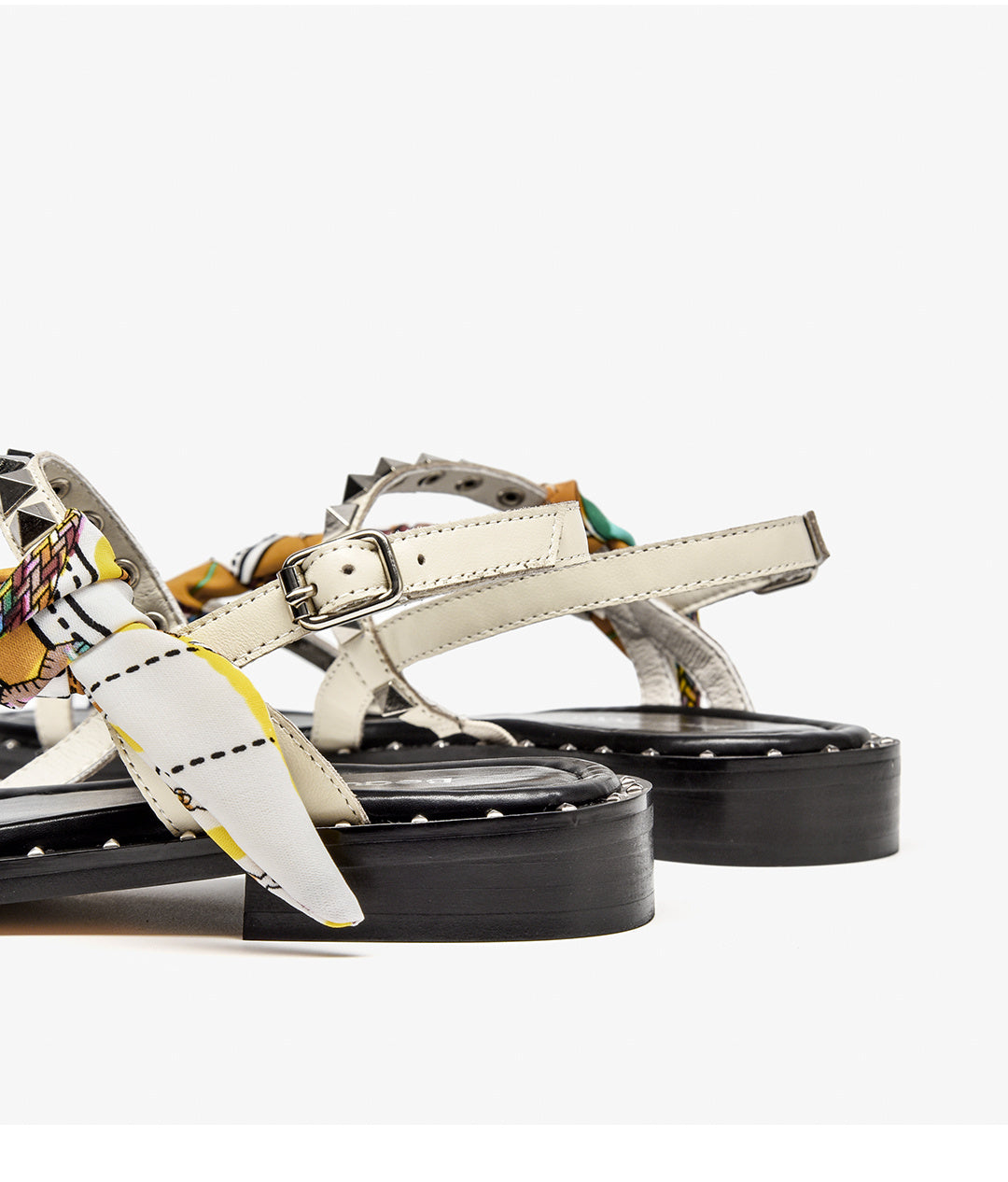 White sandals with colorful straps on a white background