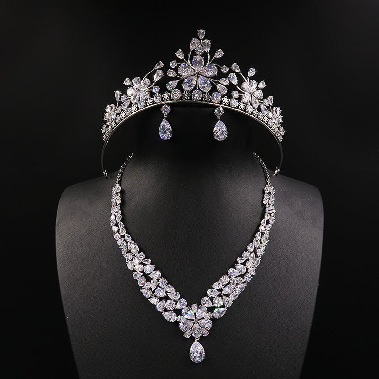 Diamond tiara and necklace set on a black mannequin against a black background