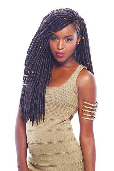 Woman with long braided hair wearing a gold dress against a white background