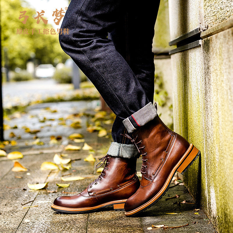 Person wearing brown leather boots with a blurred outdoor background