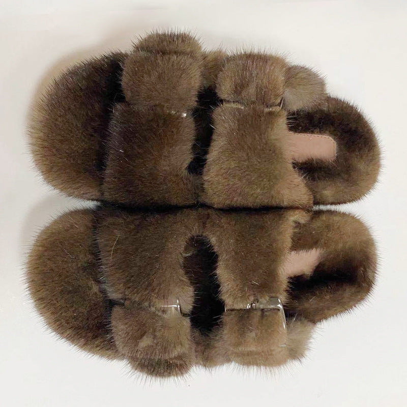Pair of brown fur slippers on a white background